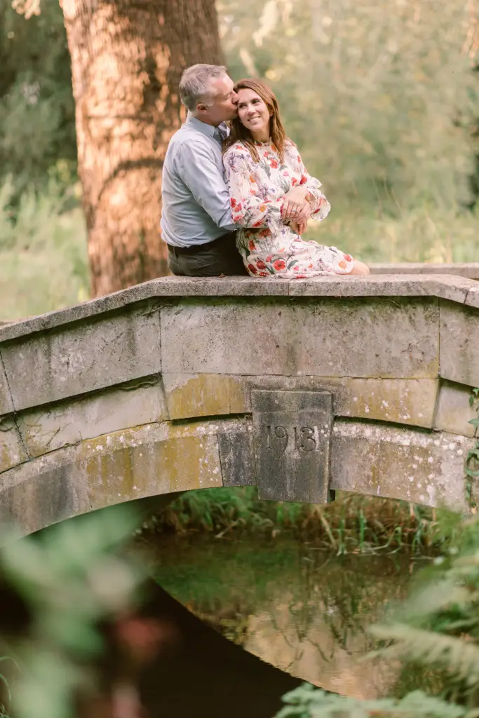 Couple sitting on a stone bridge